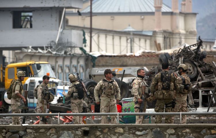 Afghan security forces inspect the site of a coordinated attack by the Taliban on a key government security agency in the capital Tuesday morning. The Associated Press