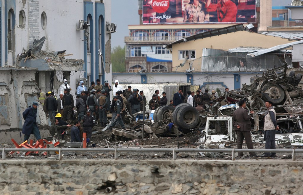 Afghan security forces inspect the site of a Taliban-claimed deadly suicide attack in Kabul. More than 300 people were injured.