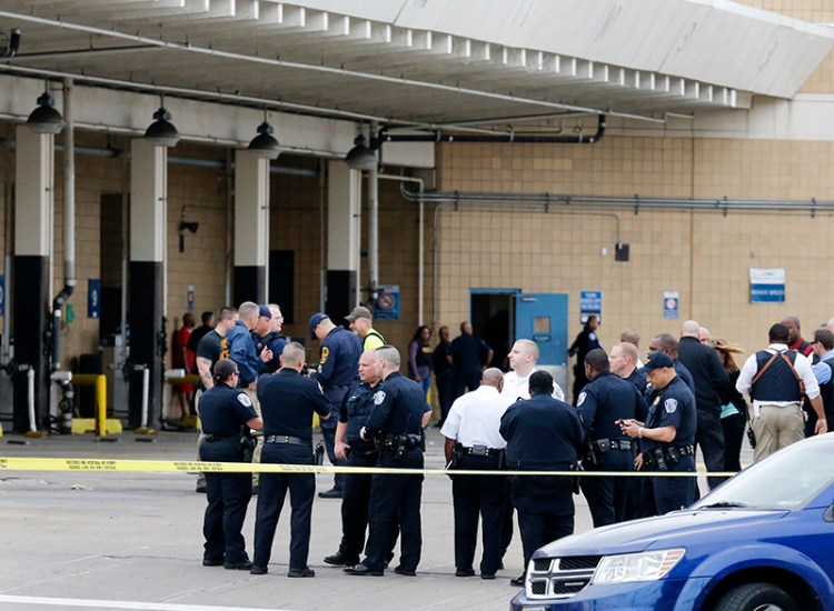 Police officers gather outside the Greyhound Bus Station in Richmond, Va on Thursday.