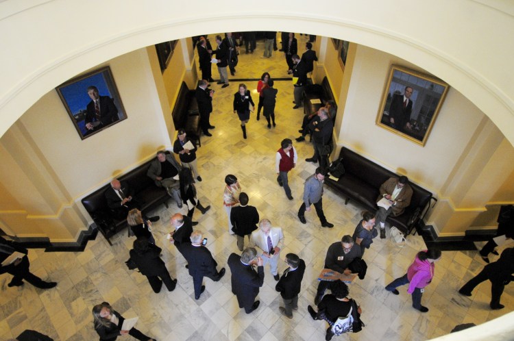 Groups in the Maine State employees Association and solar energy supporters lobby on the third floor at the Statehouse in a Augusta Friday morning before the veto day session. (Staff photo by Joe Phelan)