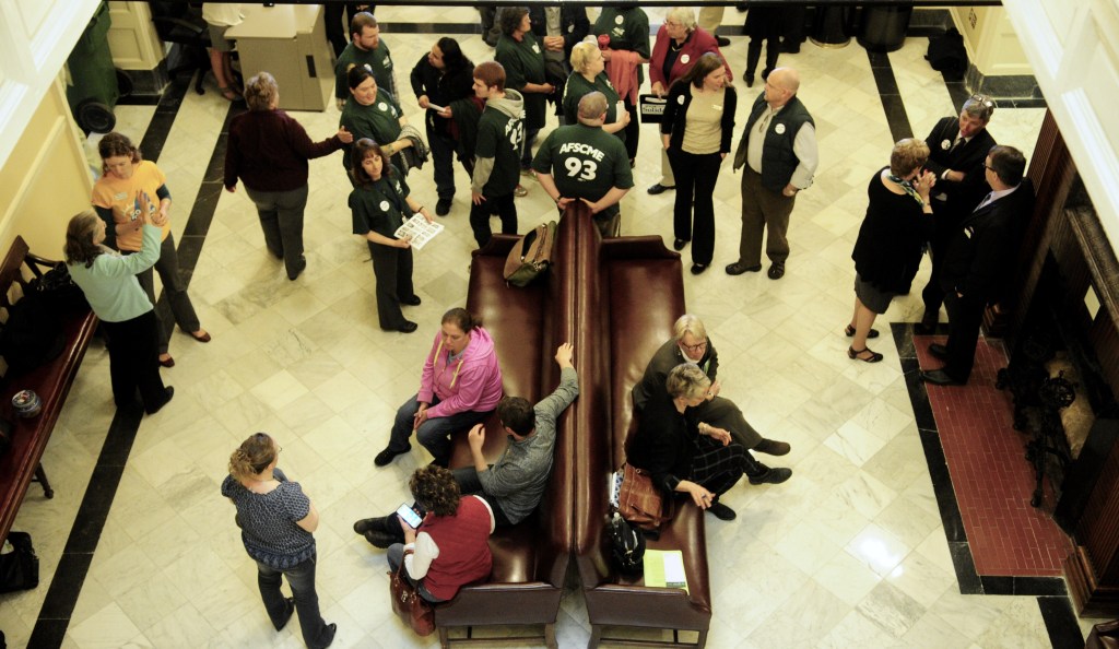 Groups in the Maine State employees Association and solar energy supporters lobby on the third floor at the Statehouse in a Augusta Friday morning before the veto day session. (Staff photo by Joe Phelan)