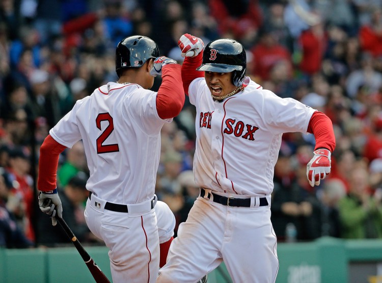 Mookie Betts celebrates his solo homer in the ninth inning against the Baltimore Orioles on Patriots Day. The Red Sox overtook the Orioles for first place in the American League East this weekend.