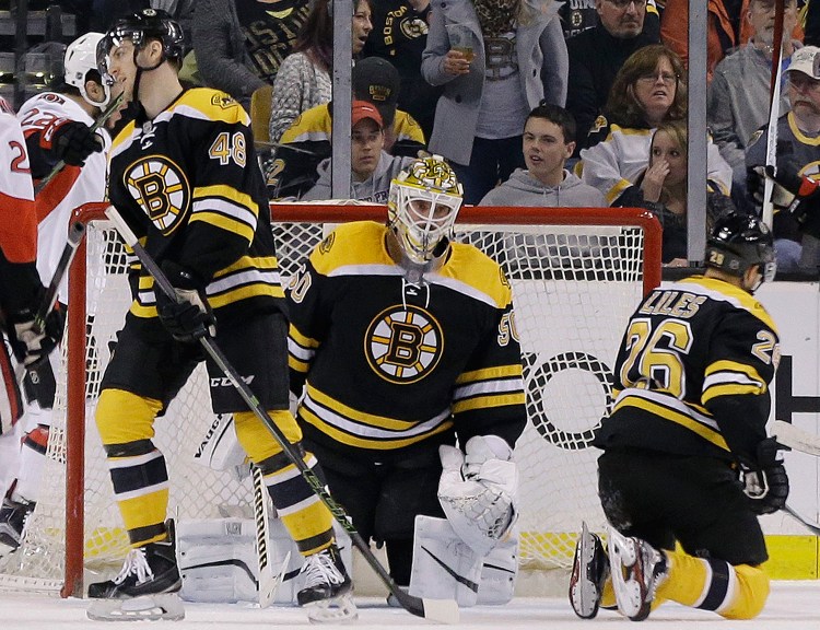 Boston Bruins goalie Jonas Gustavsson (50) reacts along with teammates defensemen Colin Miller (48) and John-Michael Liles (26) after the Ottawa Senators scored in the second period of an NHL hockey game, Saturday in Boston. The Associated Press