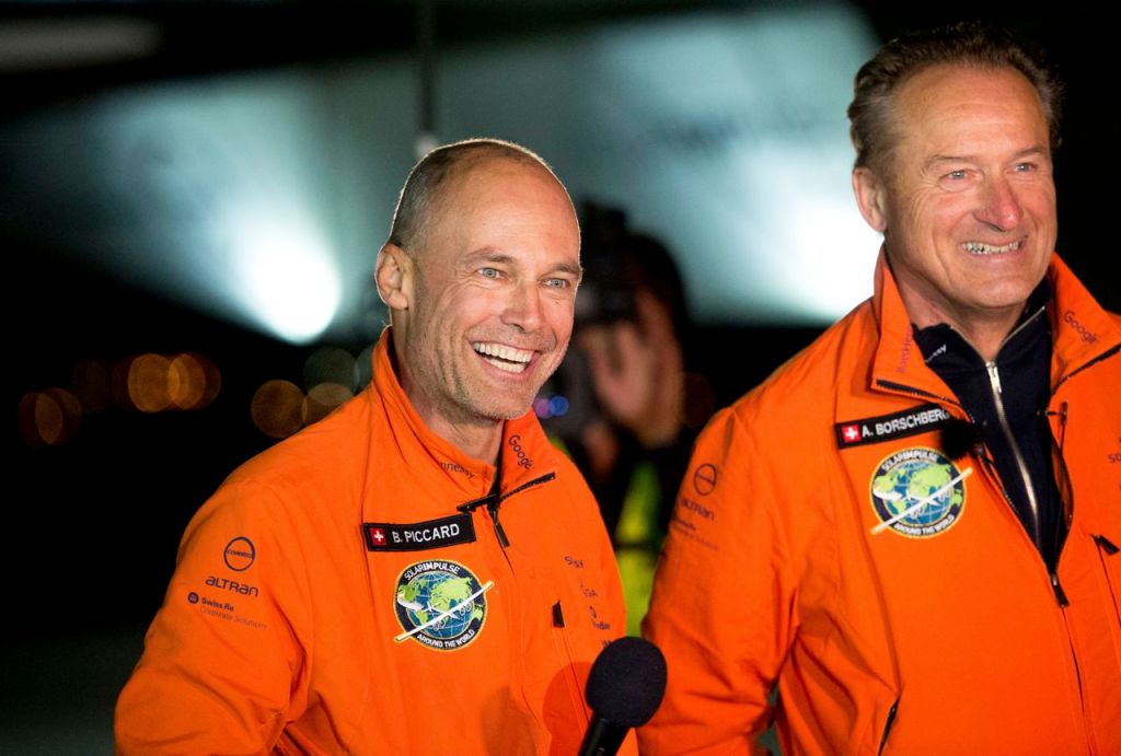 Solar Impulse 2 pilots Bertrand Piccard, left, and Andre Borschberg celebrate after Piccard landed their solar-powered plane at Moffett Field in Mountain View, Calif.,  on Saturday. The Associated Press