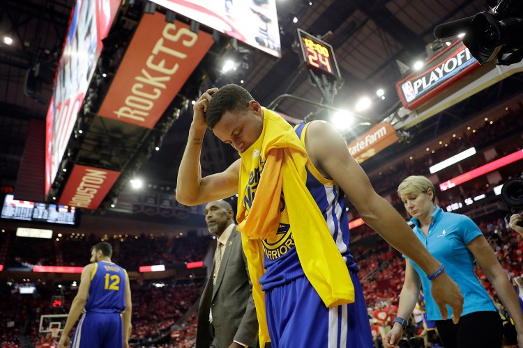 Golden State Warriors' Stephen Curry heads off the court and to the locker room at the start of the second half in Game 4 of a first-round NBA basketball playoff series against the Houston Rockets Sunday. Curry was injured at the end of the first half. 