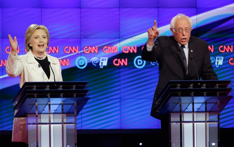 Hillary Clinton and Bernie Sanders try to speak over one another during Thursday's night's Democratic debate./Associated Press photo