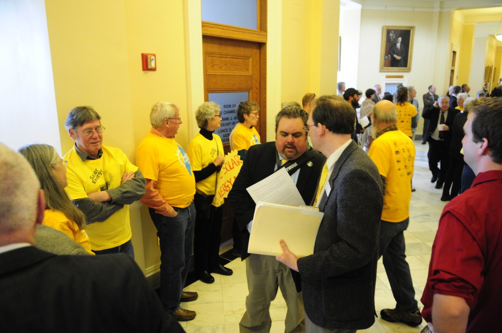 Advocates of a bill that aims to increase solar energy generation in Maine gather at the State House in Augusta Friday morning as lawmakers consider overriding Gov. Paul LePage's veto of that and dozens more bills. (Staff photo by Joe Phelan)