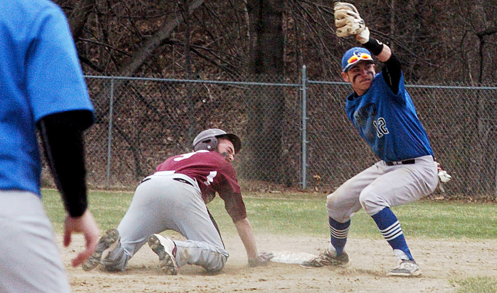 University of Maine at Farmington's Jordon Croteau and Colby-Sawyer's Tim Donovan both look to the umpire for the call during game Sunday in Farmington. Croteau was called out.