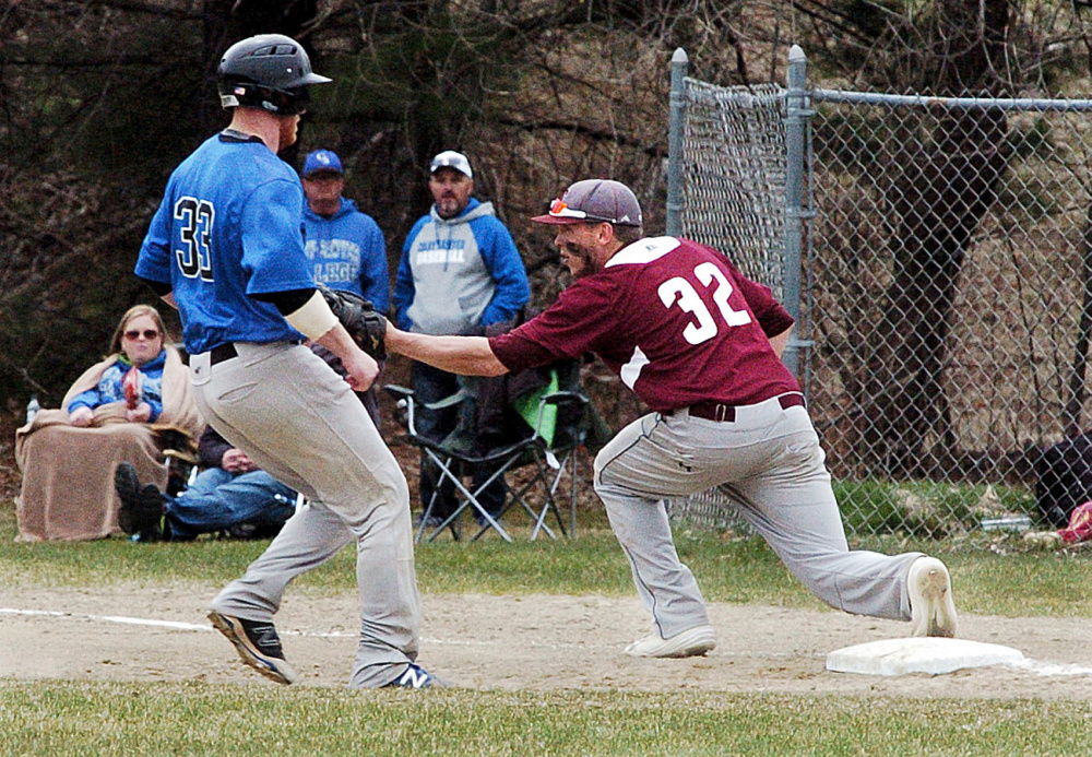 University of Maine at Farmington's Ben Keene tags out Colby-Sawyer's Conner Henry on Sunday in Farmington.
