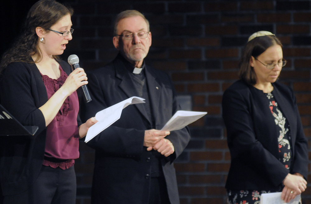 Elizabeth Helitzer sings during a service Sunday with Catholic priest Frank Morin and Rabbi Erica Asch on the Holocaust Day of Remembrance hosted by the Holocaust and Human Rights Center of Maine in Augusta.