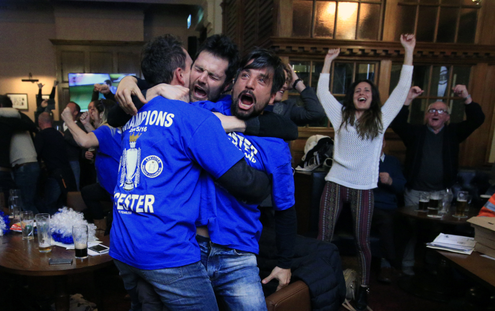 Leicester City fans react in Hogarths public house in Leicester, central England, after Chelsea's Eden Hazard scored the tying goal against Tottenham Hotspur in an English Premier League soccer match Monday. The match ended 2-2 resulting in Leicester City winning the Premier League, one of the biggest upsets in the history of sports.