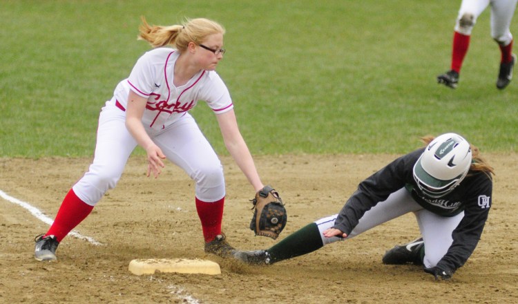 Cony shortstop Autumn Sudsbury tries to tag Oxford Hills baserunner Cora Hooker at third base during a Kennebec Valley Athletic Conference Class A game Wednesday at Cony Family Field in Augusta.