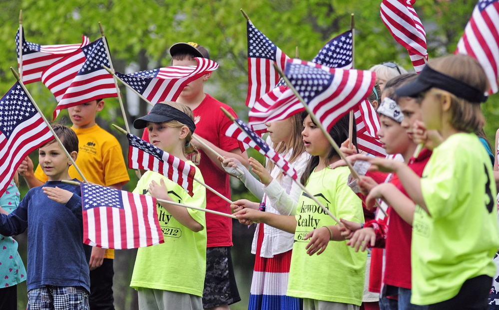 File photo 
 Wayne Elementary School students sing, "You're A Grand Old Flag" during Memorial Day events last year. They'd recently learned the song from Bonnie Wilder, of the Daughters of the American Revolution Koussinoc Chapter, who taught the patriotic song during a school field trip to the Old North Wayne School.