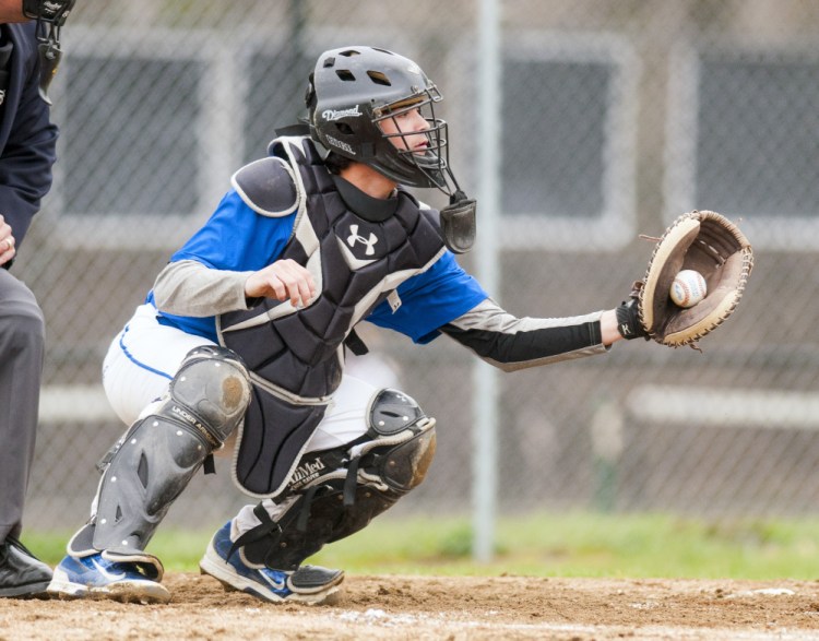 Erskine Academy catcher Nick Turcotte catches a pitch during game against Maranacook on Tuesday in Readfield.