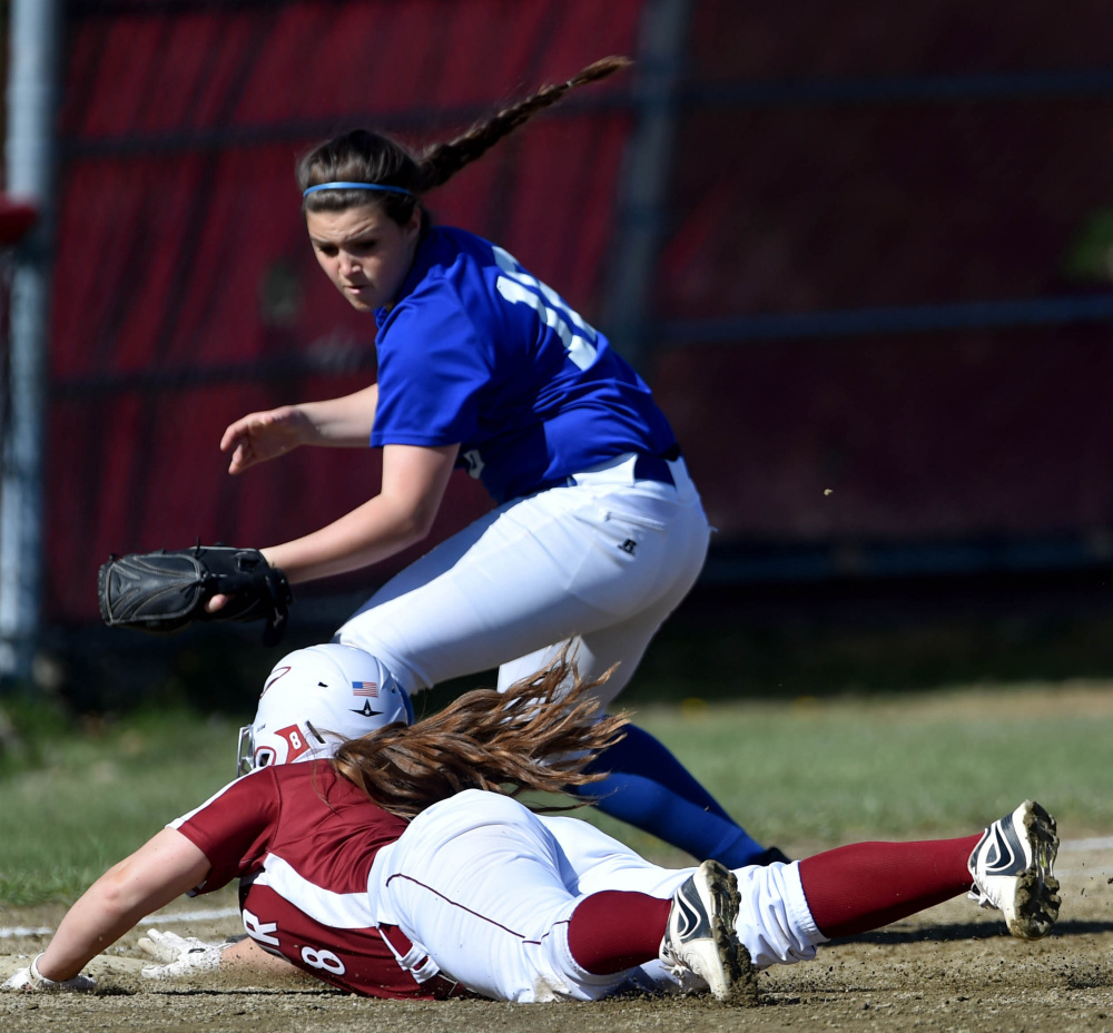 Bangor's Megan Conner (8) narrowly makes it back to first base safely as Messalonske's Katie Guarino tries to apply the tag Friday in Oakland.