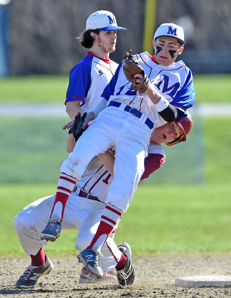 Staff photo by Michael G. Seamans 
 Bangor's Peter Kemble (19) collides with Messalonskee shortstop Jared Cunningham (12) after being forced out at second base Friday in Oakland.