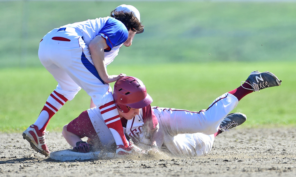 Bangor's Peter Kemble (19) slides safely into second base under the tag of Messalonskee second baseman Sam Bell (3) on Friday in Oakland.