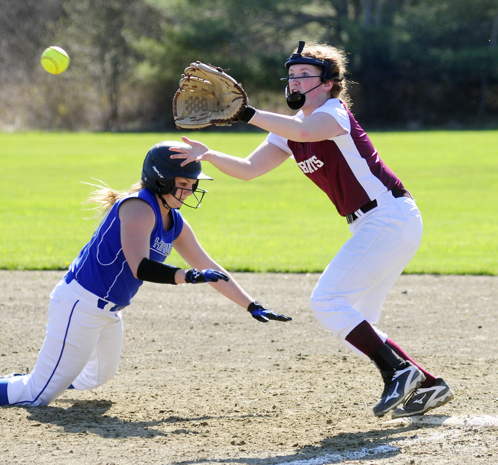 Sacopee's McKenzie Fox, left, dives back to first as Richmond first baseman Kelsea Anair waits for the throw Friday in Richmond.