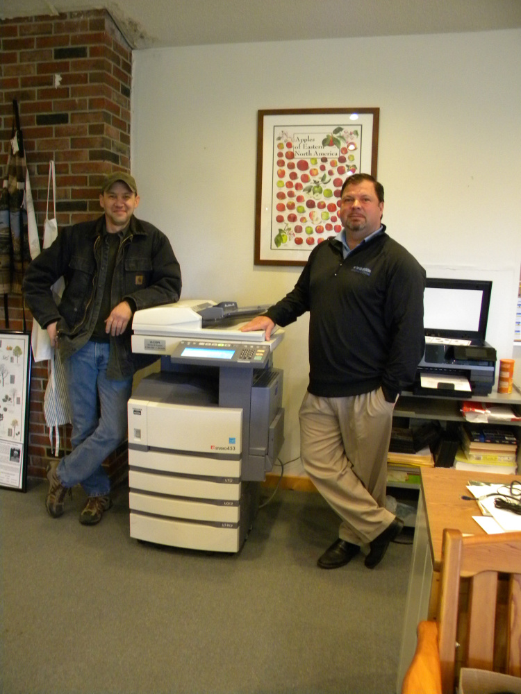 Rob Couture, left, and Dan Gallant of A-COPI Imaging Systems of Gardiner deliver and set up the Viles Arboretum's new copy machine, which the company donated.