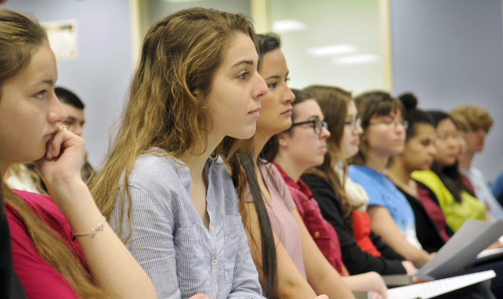 Gardiner Area High School students listen Monday to a panel discussion on women's rights at the school.