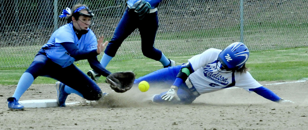 Madison runner Kayla Bess slides safely into third base as Telstar's Becca Howard awaits the throw during a Mountain Valley Conference game Monday in Madison. The Bulldogs won 3-1.