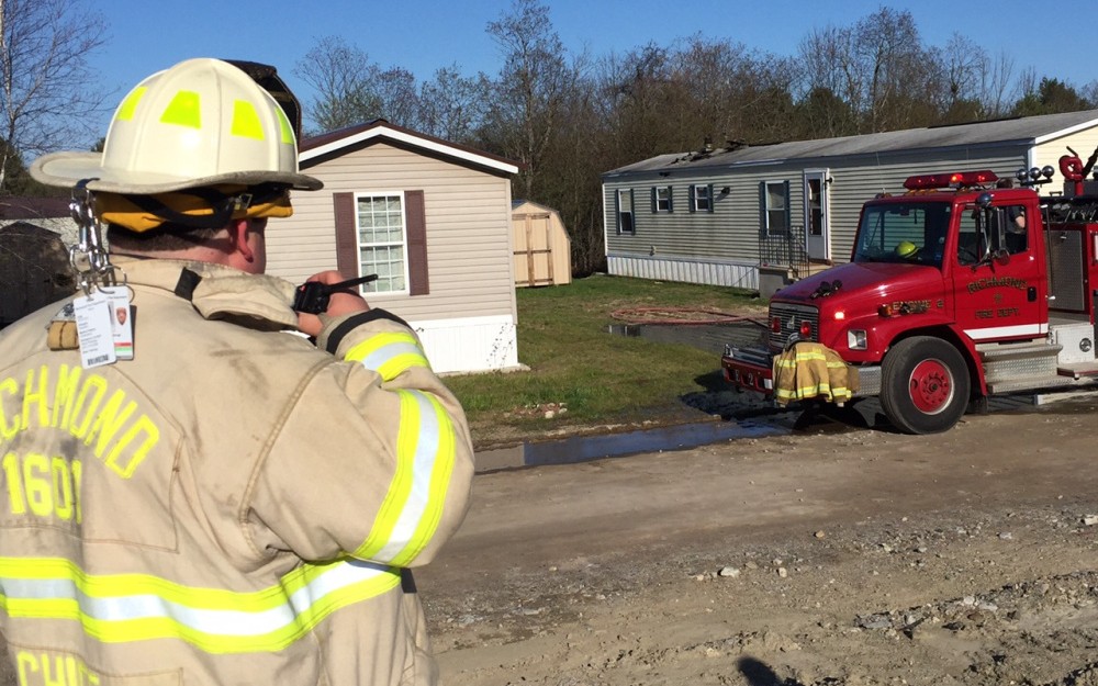 Richmond Fire Chief Matt Roberge oversees a cleanup effort after a fire damaged a Richmond mobile home Wednesday afternoon.