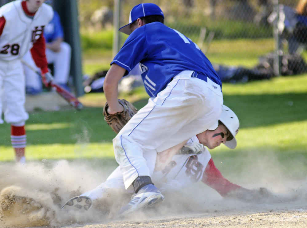 Hall-Dale's Austin Stebbins slides home under Madison's Chase Malloy during a game Wednesday in Farmingdale.
