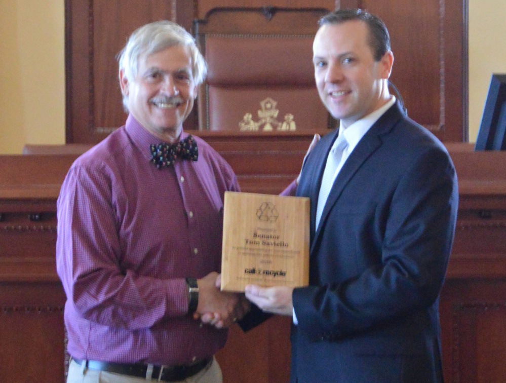 Sen. Tom Saviello, R-Wilton, recieves the Sustainabilty Award from a representative of Call2Recycle for his efforts to remove consumer batteries from the waste stream.