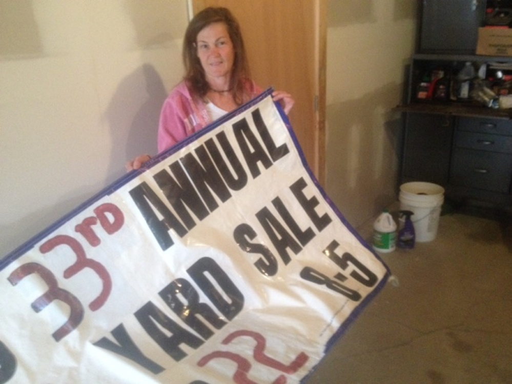Janet Bernard, of Nelson's Candies on West Ridge Road in Cornville, prepares banners Friday for the 33rd annual Cornville 10-mile yard sale, which is scheduled for May 21 and 22.