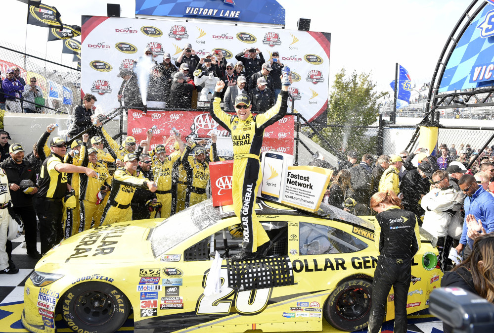 Matt Kenseth celebrates in Victory Lane after he won the NASCAR Sprint Cup race Sunday at Dover International Speedway in Dover, Delaware.