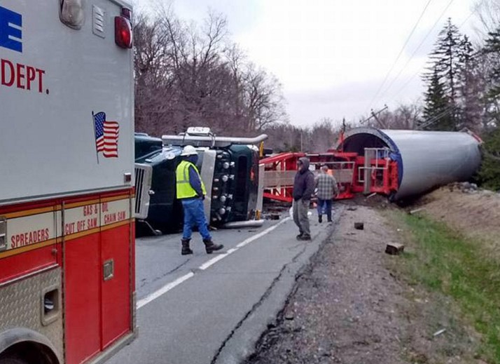 A loaded truck hauling a wind turbine base from the Quebec border to a wind energy project in Bingham rolled over Monday when the driver lost control on a corner in Johnson Mountain Township.