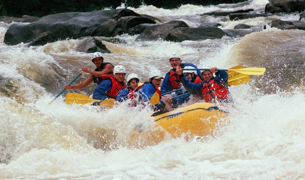 Whitewater rafters on a North Country Rivers outing paddle through the Cribworks rapids on the Penobscot River several years ago. A Massachusetts man died Saturday while on a North Country Rivers trip on the Dead River through West Forks Plantation. The Maine Warden Service said that the trip was operating in accordance with state law.
