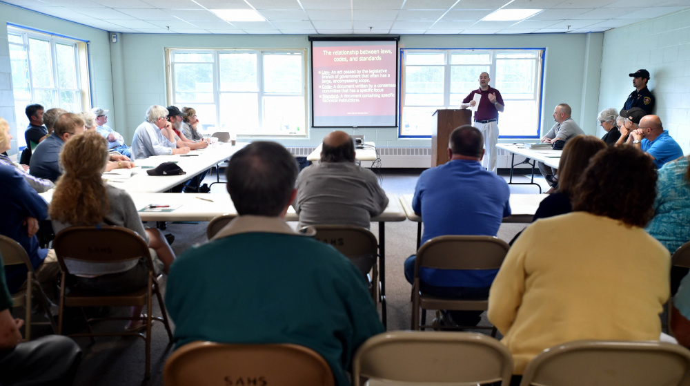 Landlords and property owners listen to Richard McCarthy, assistant state fire marshal, during a fire safety seminar at the Skowhegan Community Center on Wednesday.