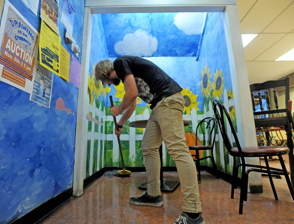 An employee mops the floor in 2014 at Jorgensen's Cafe on Main Street in downtown Waterville. The restaurant, which celebrated its 25th anniversary last year, is being sold. The new owners say they will wait to decide what changes to make to the coffee shop.