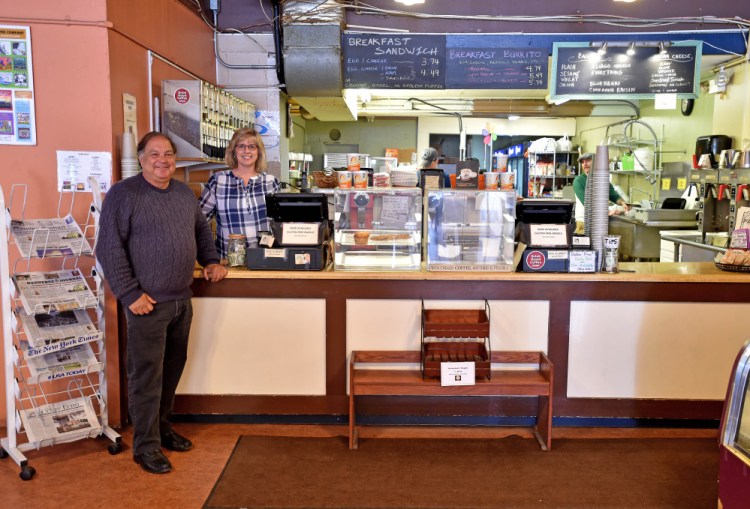 Steve Black, left, stands with Jorgensen's Cafe owner Ginny Bolduc, Wednesday in the cafe. Black was in the city representing financier Todd Robinson, who is buying the cafe, which will be run by his nephew.