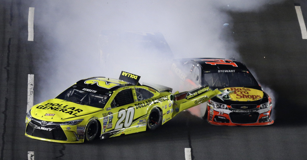 Matt Kenseth (20) is hit from behind by Tony Stewart during the NASCAR Sprint All-Star race at Charlotte Motor Speedway on Saturday night in Concord, North Carolina.