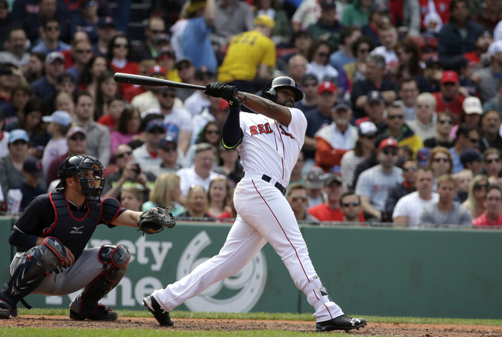 Boston's Jackie Bradley Jr., right, singles as Cleveland's Yan Gomes, left, looks on in the fifth inning Sunday at Fenway Park in Boston.