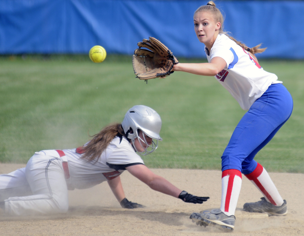 Hall-Dale's Isabella Marino, left, slides back into second base while Oak Hill's Brooke Surette waits for the throw Monday in Wales.