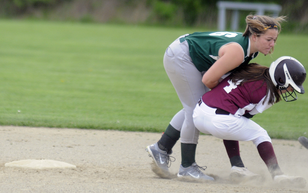 Richmond runner Meranda Martin, right, collides with Temple Academy's Jaimee Feugill by second base during an East/West Conference game Tuesday afternoon in Richmond.