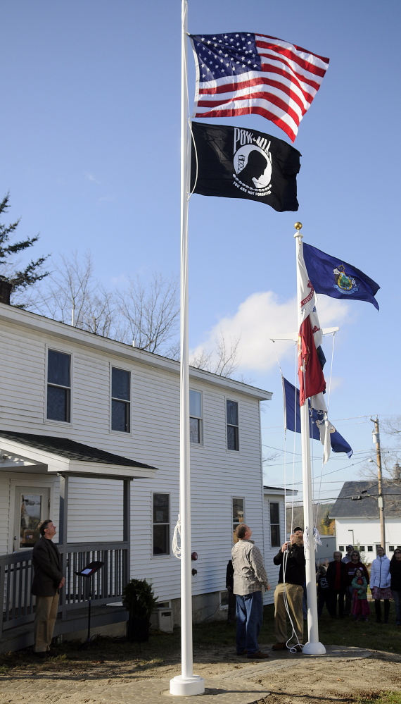 Flags fly above the Bread of Life Ministries Veterans Shelter in Augusta, where a homeless veteran says he suffered injuries during an arrest in 2012.