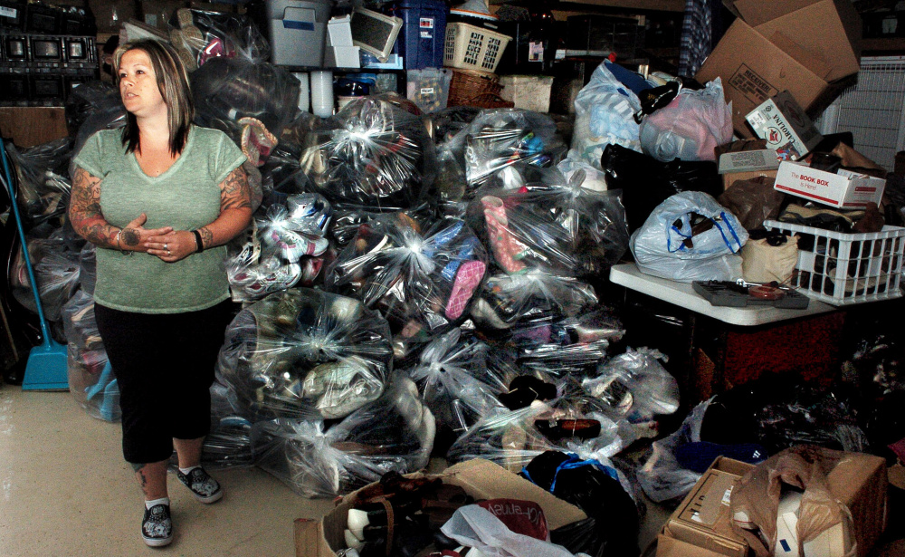 Amie Cunningham, manager of the Somerset Humane Society Animal Shelter in Skowhegan, speaks beside bags containing 2,850 pairs of shoes the organization collected that will be donated to people in impoverished countries.
