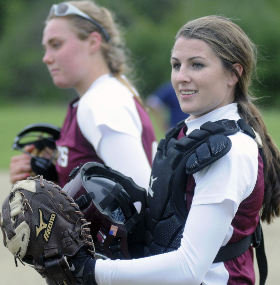 Richmond catcher Meranda Martin, right, stands by teammate Sydney Tilton on Tuesday during a game with Temple Academy.