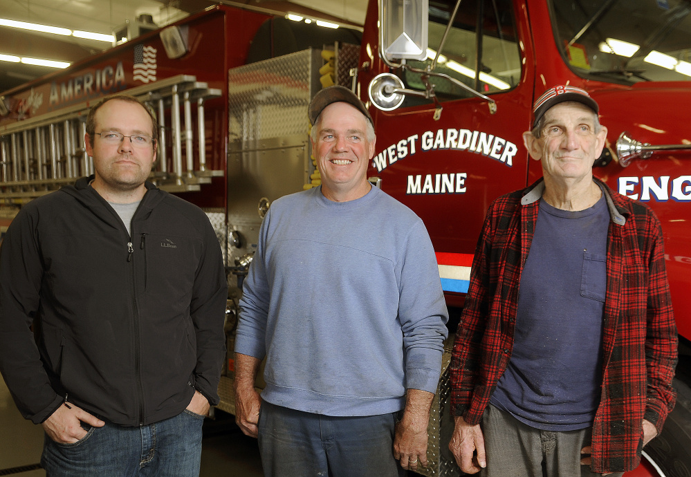 Three generations of Hickeys serve the town of West Gardiner. From left, Gary Hickey II, who is the town's volunteer fire chief; his father, Gary, who is the road commissioner; and his grandfather, Selectman Mert Hickey, gather last week at the fire station in West Gardiner.