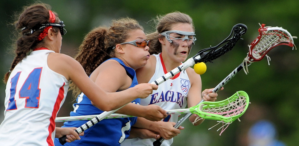 Lewiston's Alasia Branche, middle, battles for the ball with Messalonskee's India Languet (14) and Lauren Pickett during an Eastern Maine Class A semifinal game last season at Thomas College in Waterville.