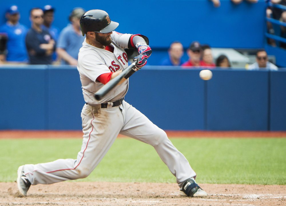 Boston Red Sox's Dustin Pedroia hits an RBI double against the Toronto Blue Jays during the 11th inning Sunday in Toronto.