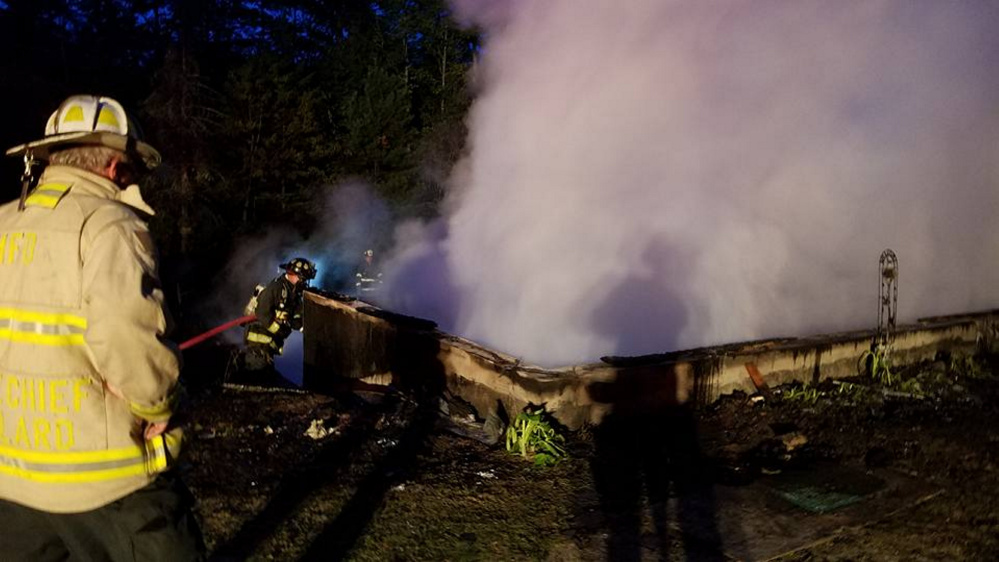 Firefighters douse embers in a basement at 141 Tillson Road in Monmouth. A two-story, single-family home there was destroyed in an early morning blaze Monday. No one was home at the time and no one was injured, according to Monmouth Fire Chief Dan Roy Jr.