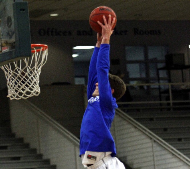Colby College guard Pat Dickert goes up for a dunk prior to a game last season. Dickert, who is listed at 6-foot-2, made national headlines after he posted a video of himself dunking from behind a foul line.