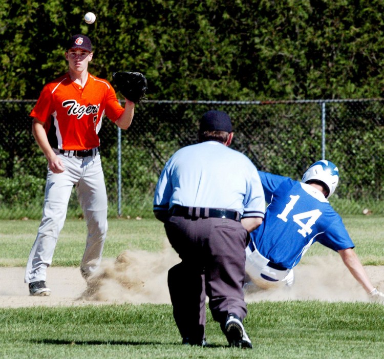 Erskine runner Luke Peabody makes it to third base as Gardiner third baseman Nic Berube waits for the throw during a Kennebec Valley Conference Class B game Tuesday in Gardiner.