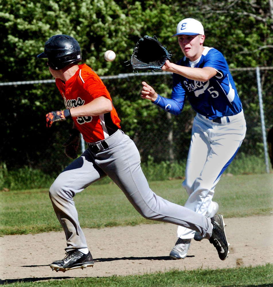 Erskine shortstop Dylan Presby fields the ball as Gardiner runner Isiah Swan heads to third during a Kennebec Valley Athletic Conference Class B game Tuesday in Gardiner.