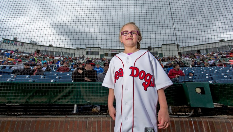 Emma Dube, a liver cancer survivor, prepares to run the bases at Hadlock Field. Emma is this year's first "Heroes at Hadlock" honoree. Ben McCanna/Staff Photographer